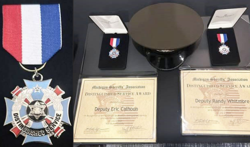 An arrangement of two Michigan Sheriffs' Association Distinguished Service Awards. On the left is a close-up of the medal, featuring a red, white, and blue ribbon attached to a cross-shaped silver medal with a light blue inlay and a central sheriff's star encircled by the words "DISTINGUISHED SERVICE". The right side displays a service cap flanked by the two boxed medals, each sitting above its respective framed certificate. One certificate is issued to Deputy Eric Calhoun and the other to Deputy Randy Whitmore, both recognizing exemplary achievements on July 4, 2025, in Van Buren County.